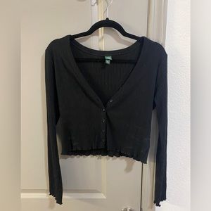 black long sleeve crop top with asymmetrical hem